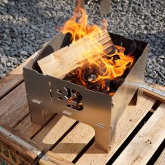 Steckbare Blazebox Cube mini Feuerschale aus Edelstahl mit brennendem Feuerholz auf Terrasse